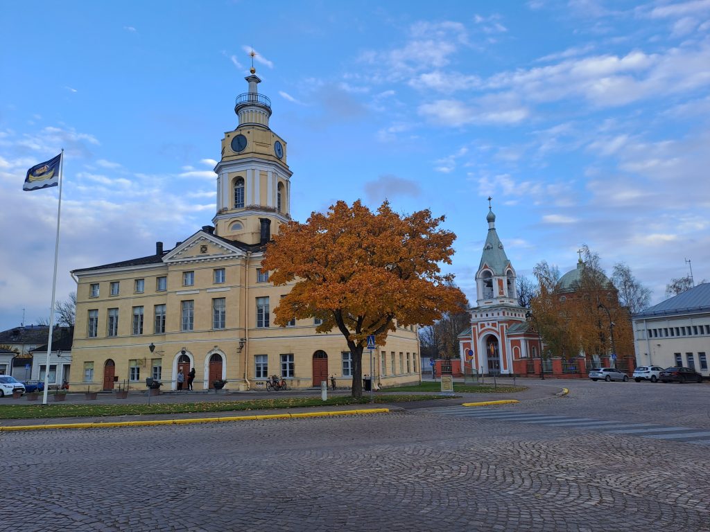 Raatihuone, jonka edessä puu ruskan väreissä.